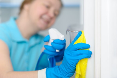 Cleaner sorting recyclable waste into separate containers during a Shoreditch deep clean