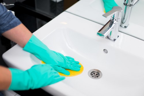 Domestic cleaner tidying a bathroom in Shoreditch